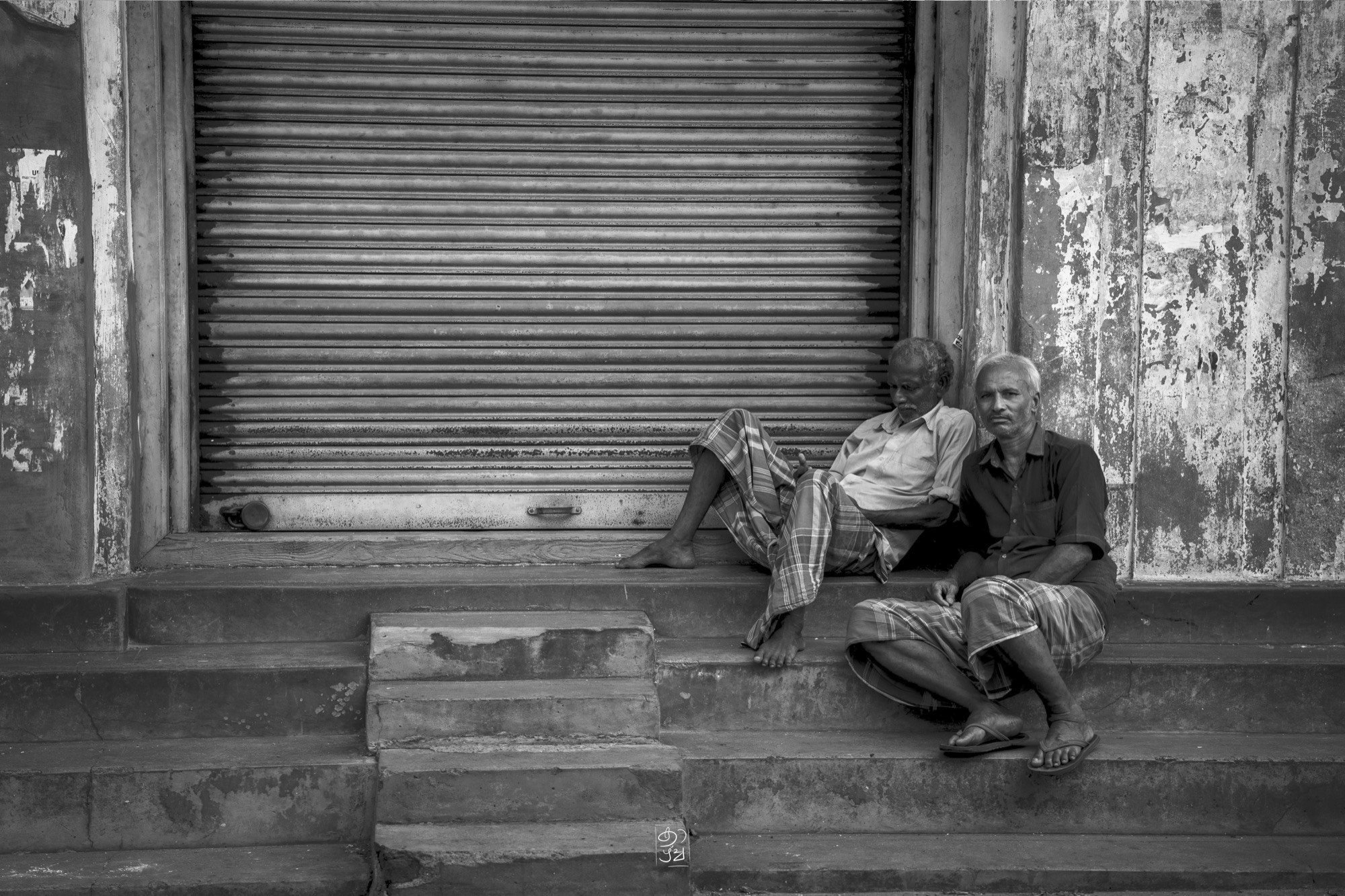 Three men sitting out the afternoon on the steps