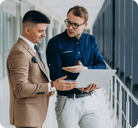 Two business professionals reviewing financial documents and payment workflows.