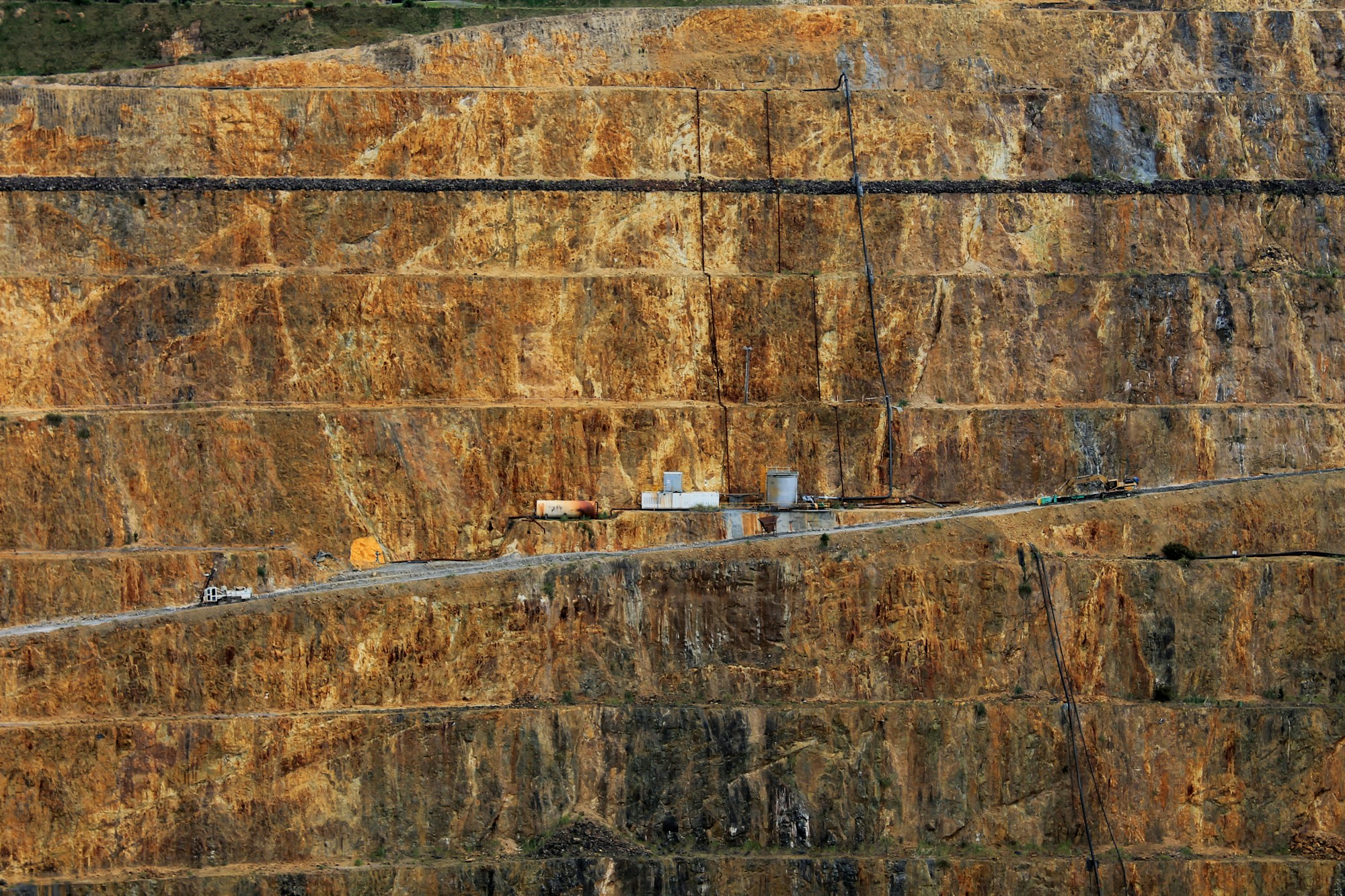 Terraced walls of an open-pit iron ore mine
