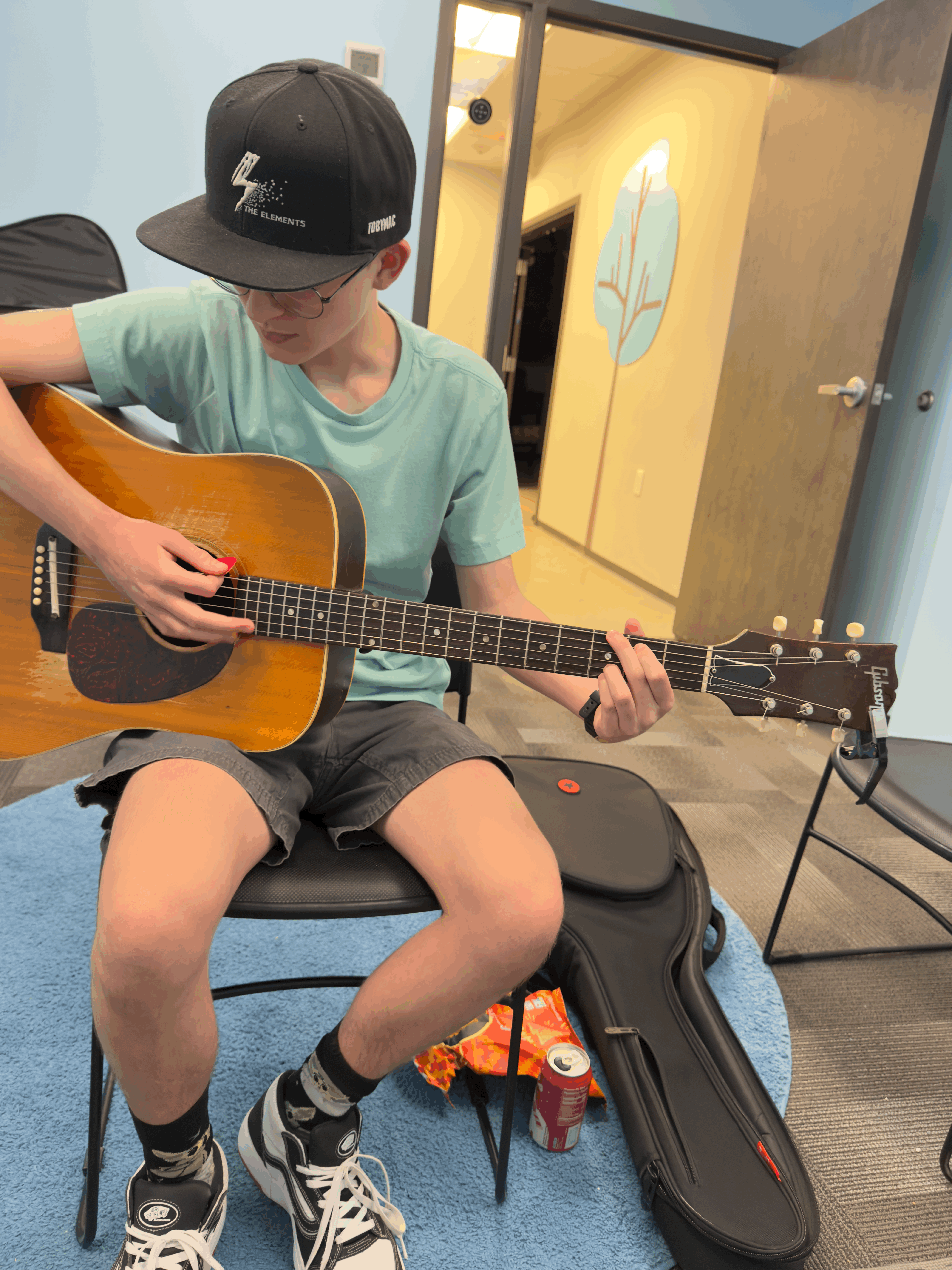 Music producer sitting on a chair in his studio