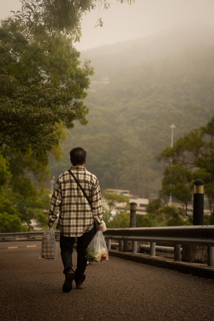 the father walking down the slope towards home