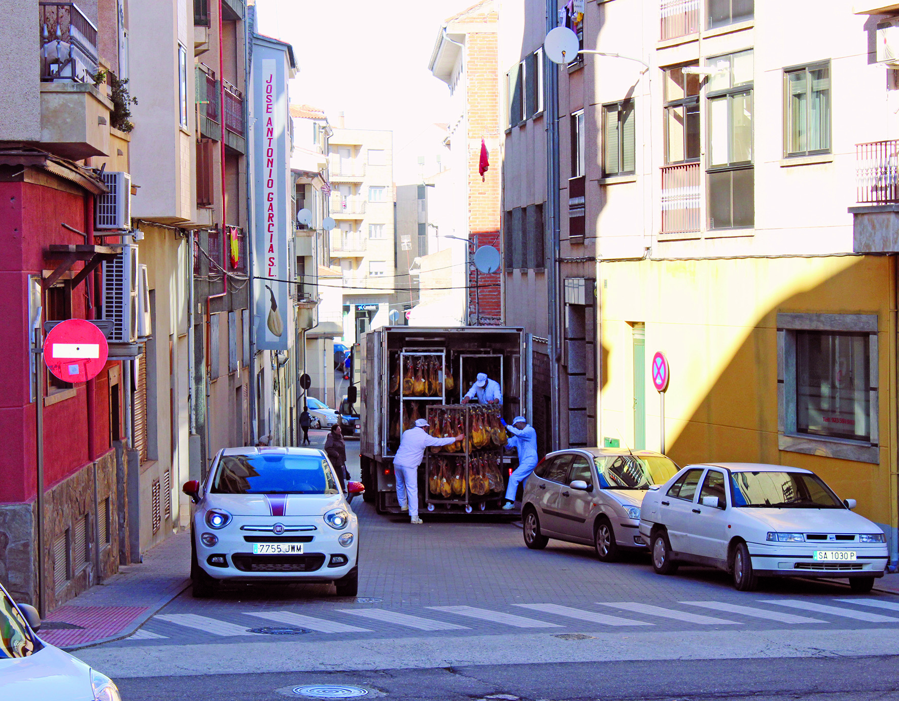 Lorry unloading hams in the street