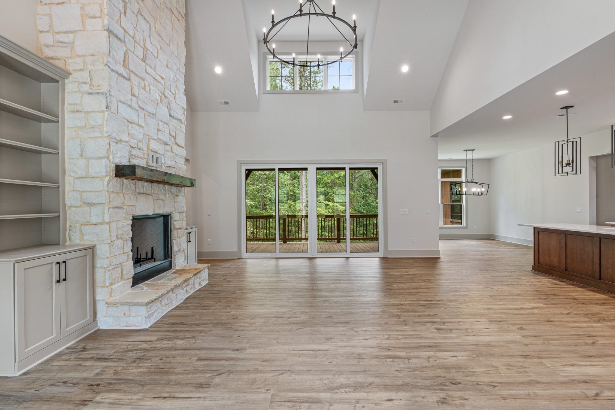 Spacious bedrrom with hardwood floors and large windows