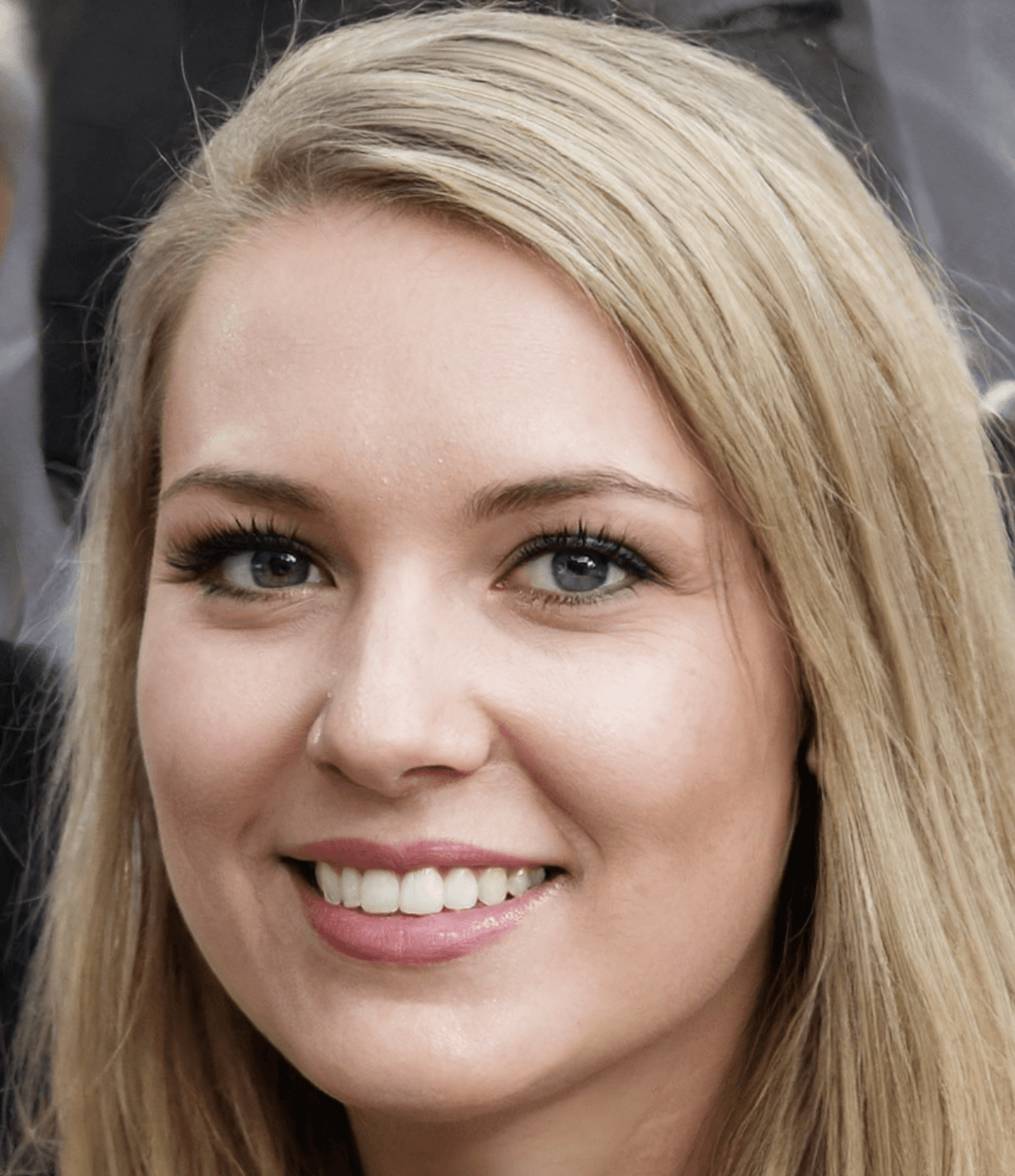 A person in a white shirt black coat with the fair skin looking infront