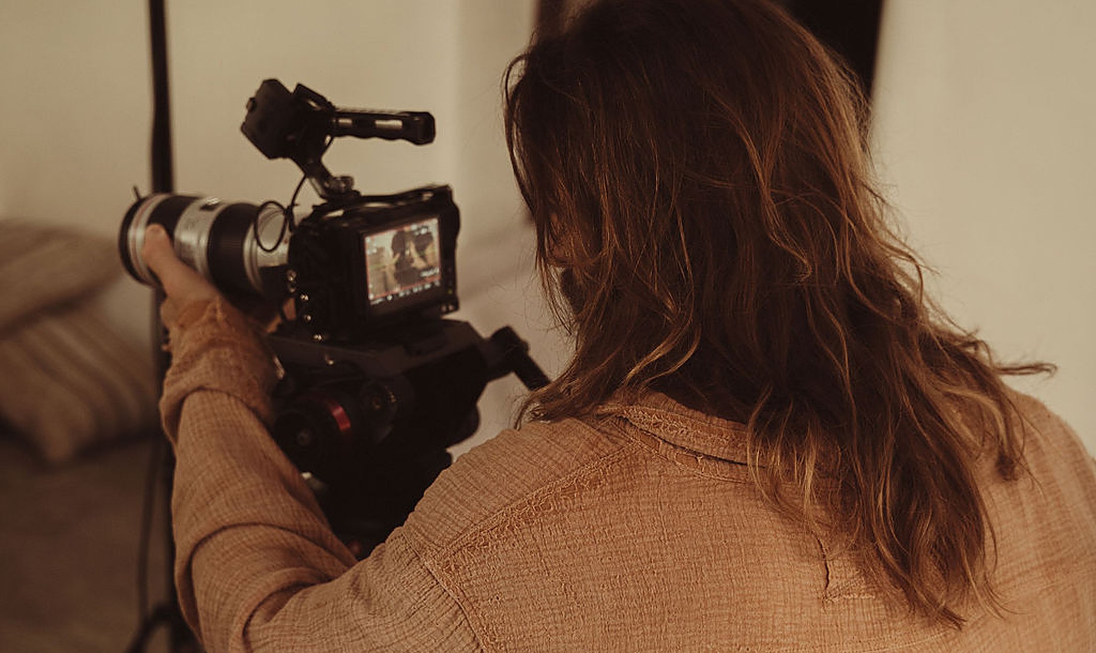 A cinema camera filming lesson content in a warm studio, the care behind Temple's online intimacy courses | My Temple