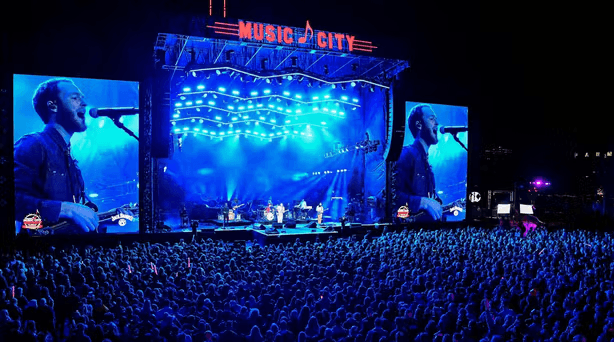 Concert stage with performer screen and crowd