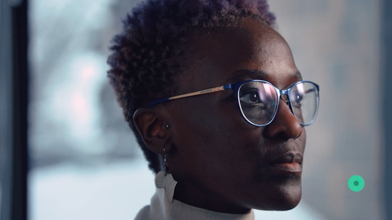 Woman wearing glasses looking to the right.