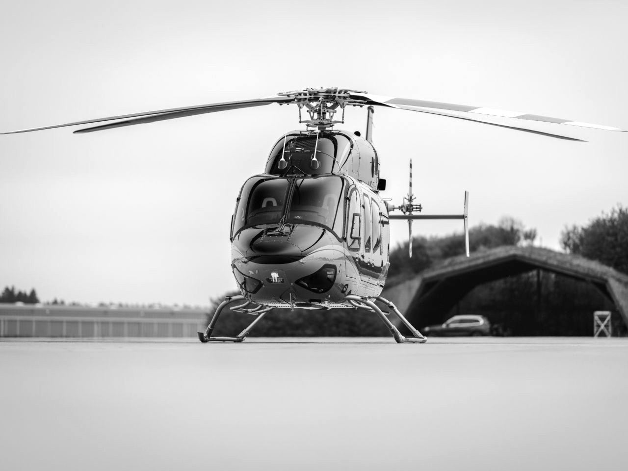 Hands carefully folding a white linen napkin into a decorative shape on a dark dinner plate, showcasing bespoke in-flight dining presentation