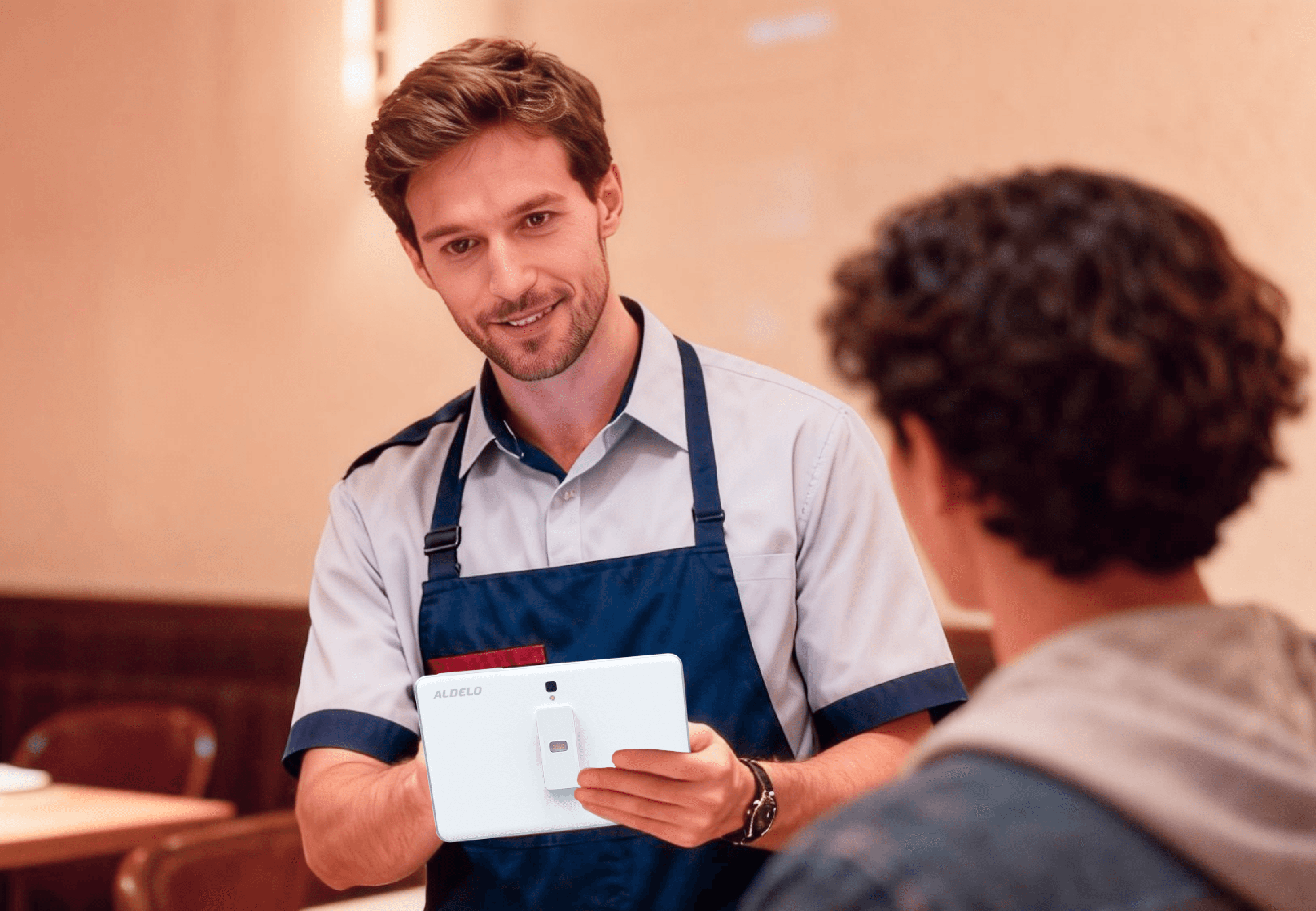 Aldelo ePay male clerk using it in front of a customer.