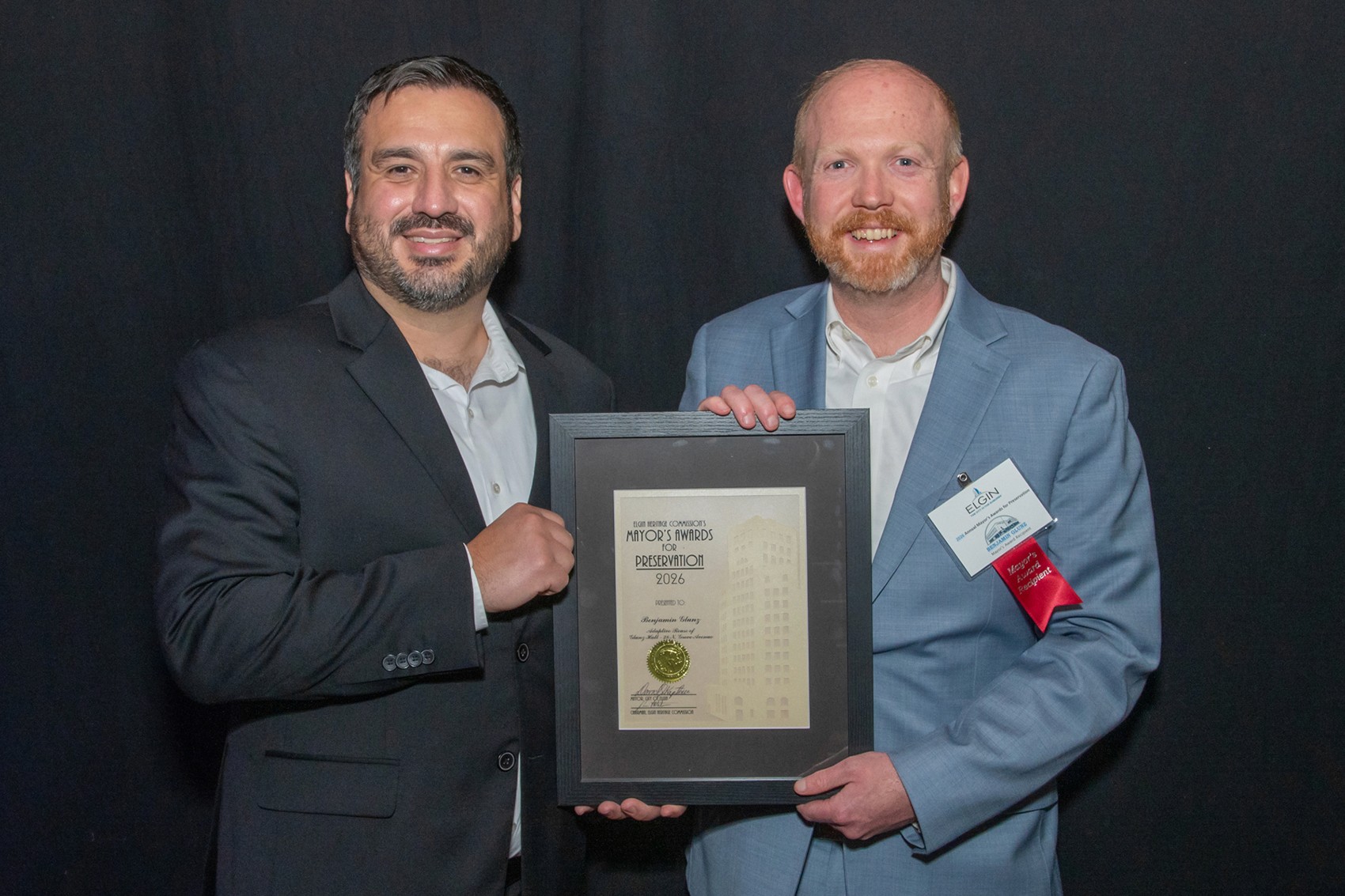 Freddy Munoz and Benjamin Glunz holding the 2026 Mayor’s Award for Historic Preservation 