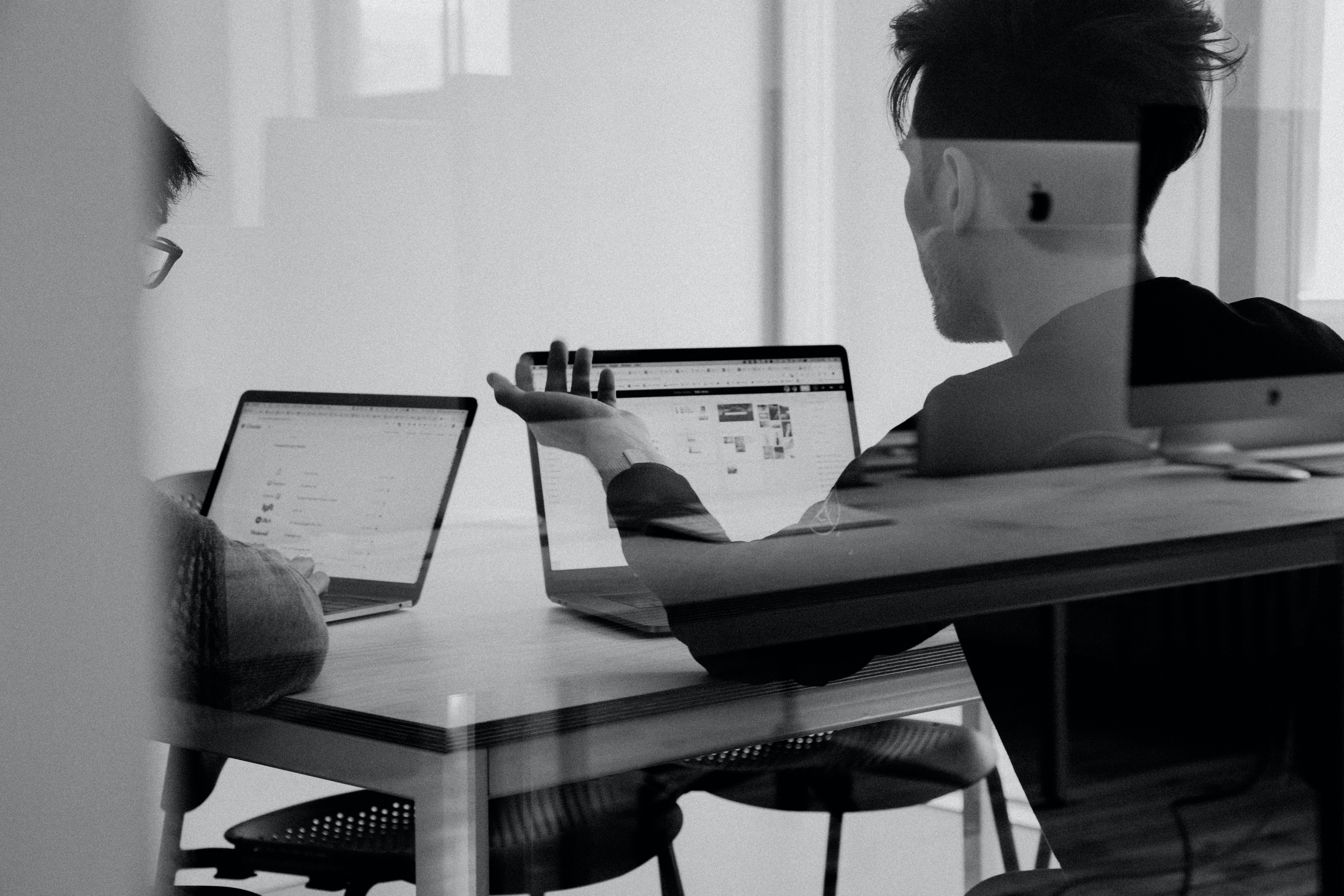 Collegues looking at their laptops.