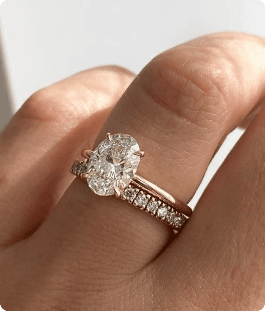 Man places ring on woman's finger with blue background