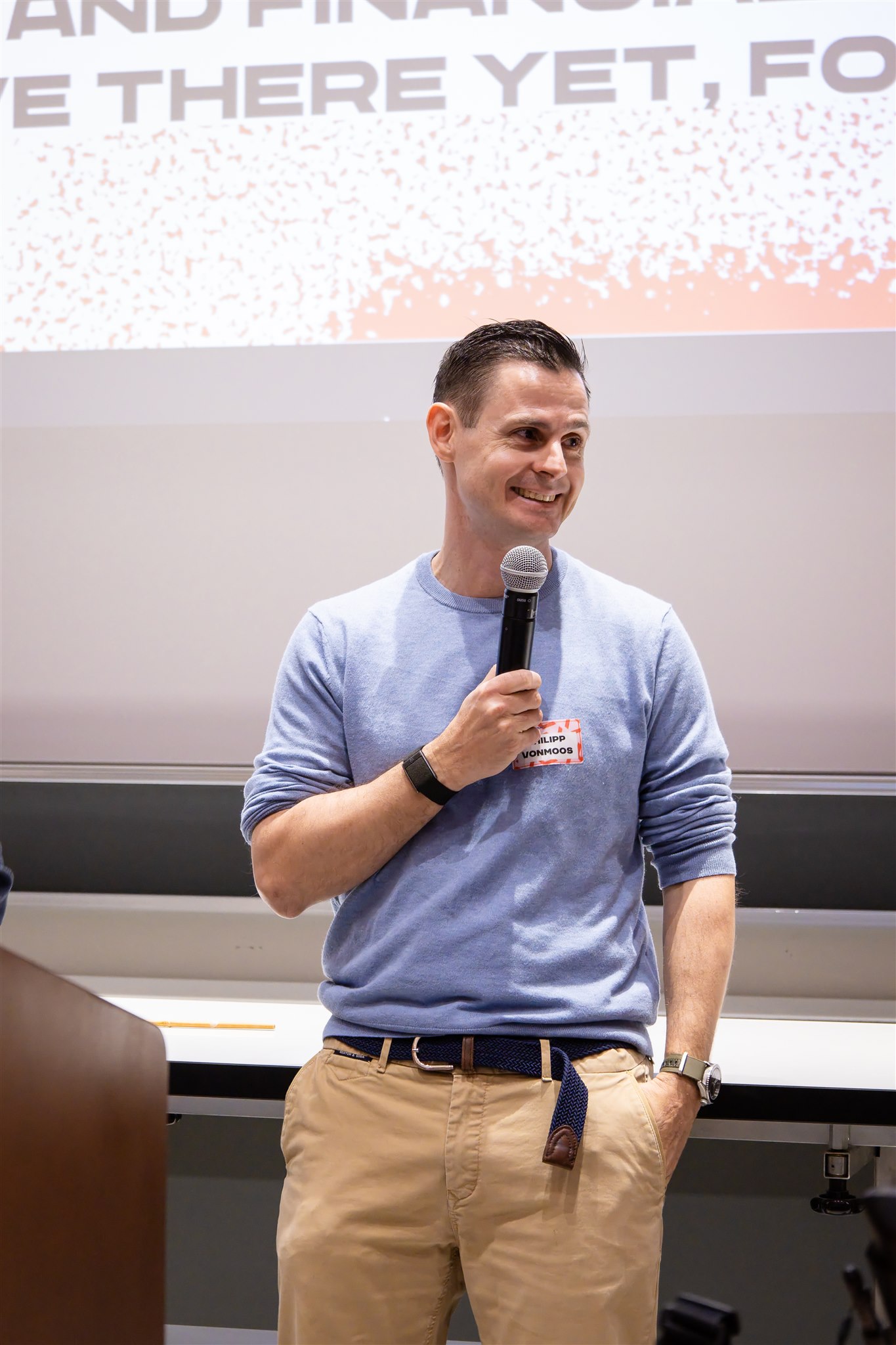 Speaker smiling while presenting at EthereumZüri event in Zurich