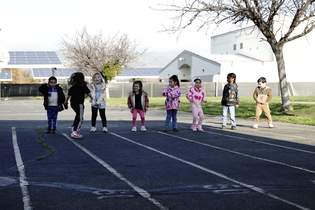 Children participating in outdoor activities during a HOKALI aftercare program at an elementary school