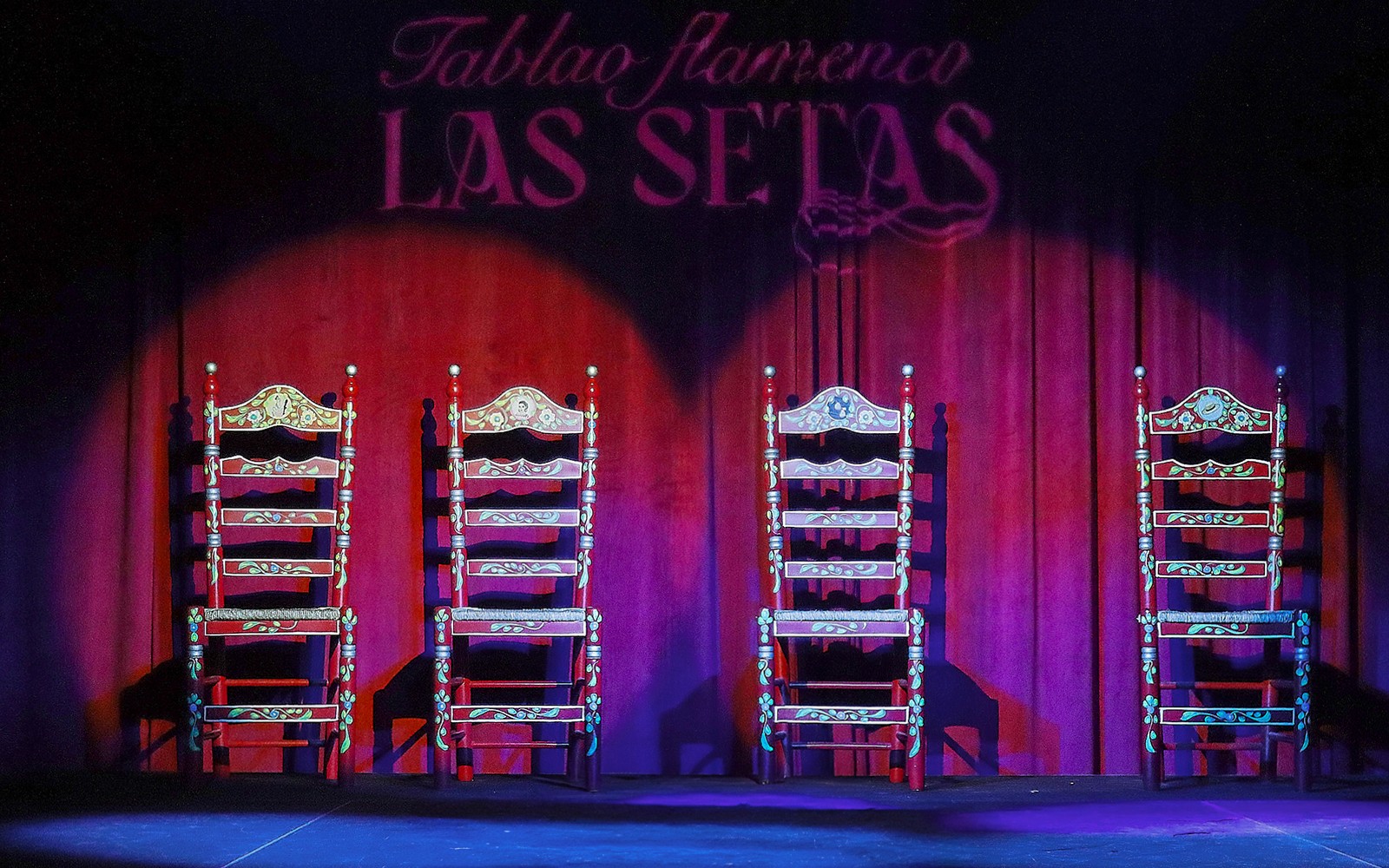 Four ornate chairs on stage at Tablao Flamenco Las Setas, Seville.
