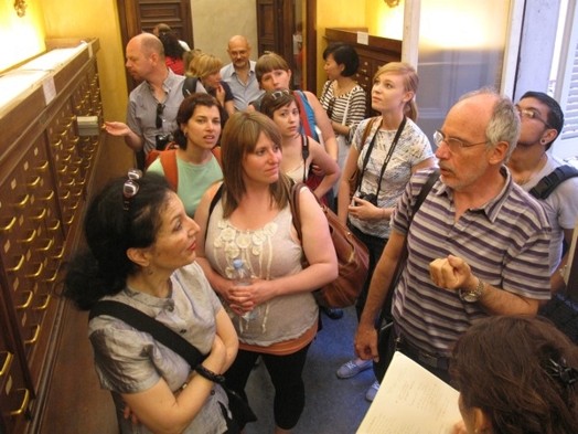 A group of people chatting in the hallway of a library.