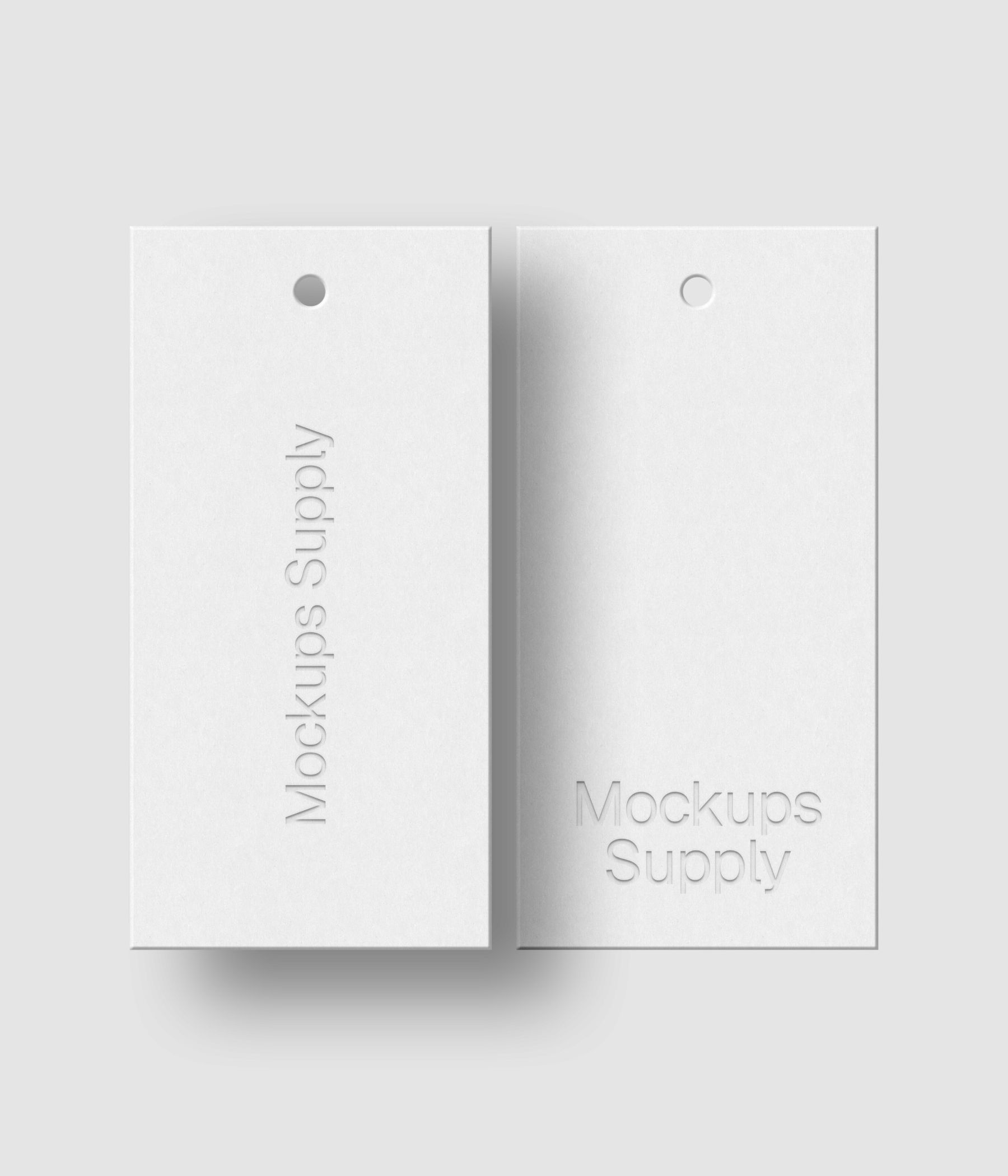 Two white 1x2 hang tags mockup on white background with debossed logo effect and soft shadow for Photoshop download psd