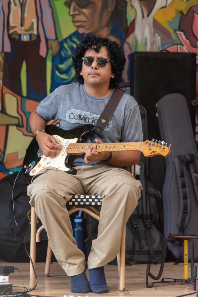 Guitarist Sanket Nashikkar performing during an immersive wellness event at High Spirits Pune