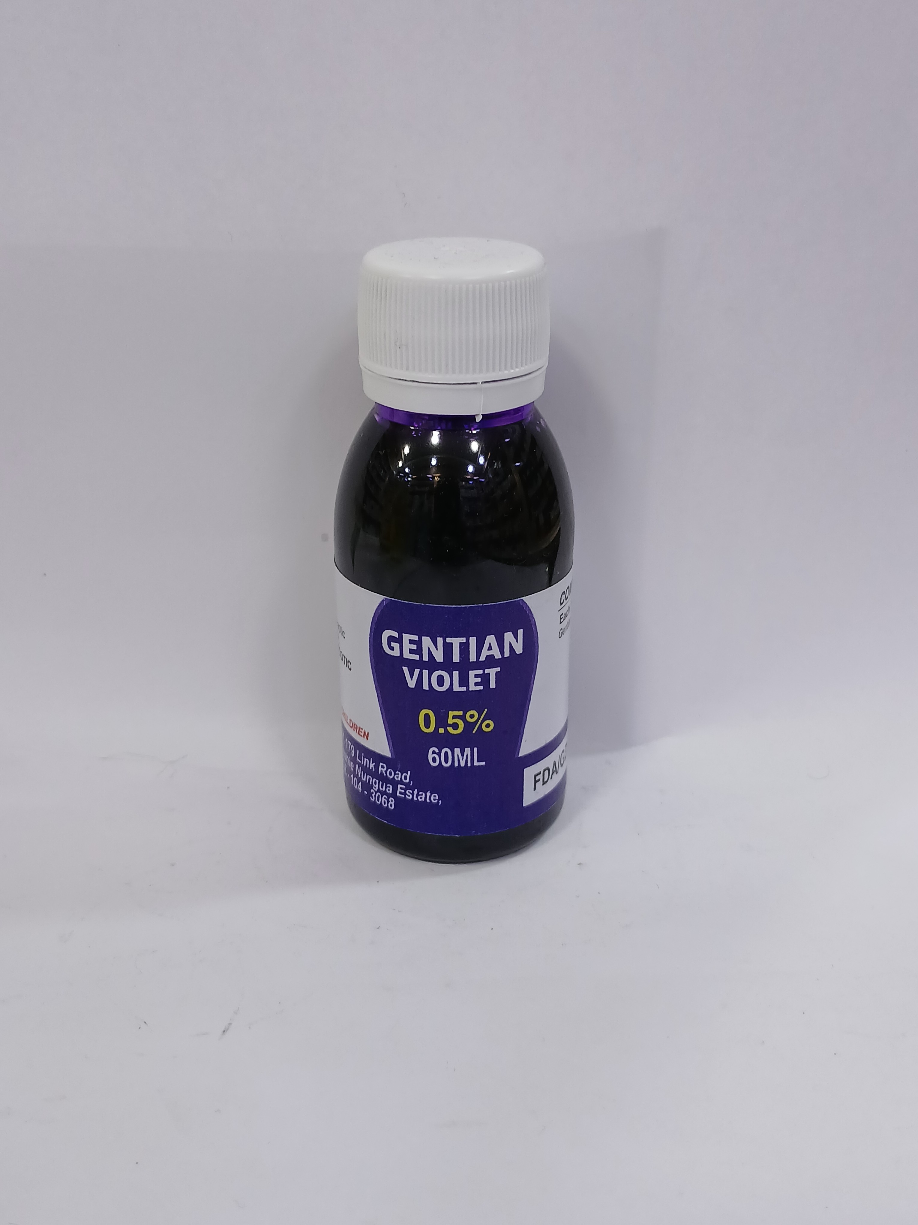 A small plastic dropper bottle with a white cap contains a dark purple liquid, labeled with blue text indicating a 0.5 percent concentration and 60 milliliters volume.