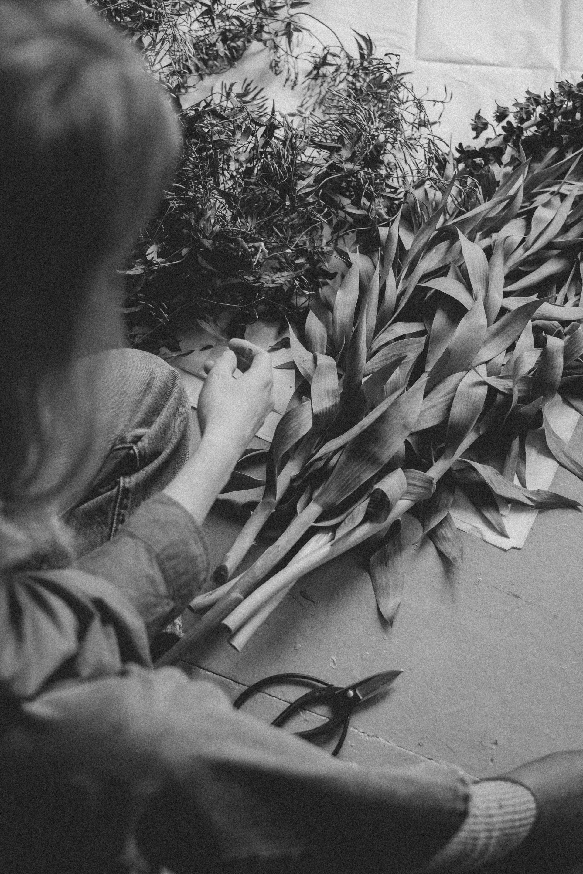Black white iamge of founder Jessica Jone arranging flowers