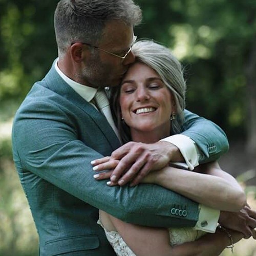 Professional headshot of a person in a formal setting.