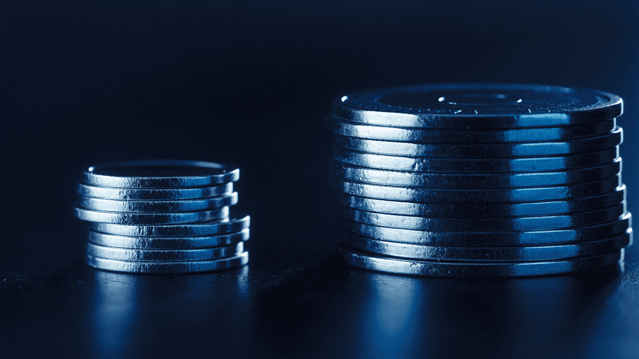 A small stack of chips beside a much larger stack, representing risking only a small portion of the account on each trade