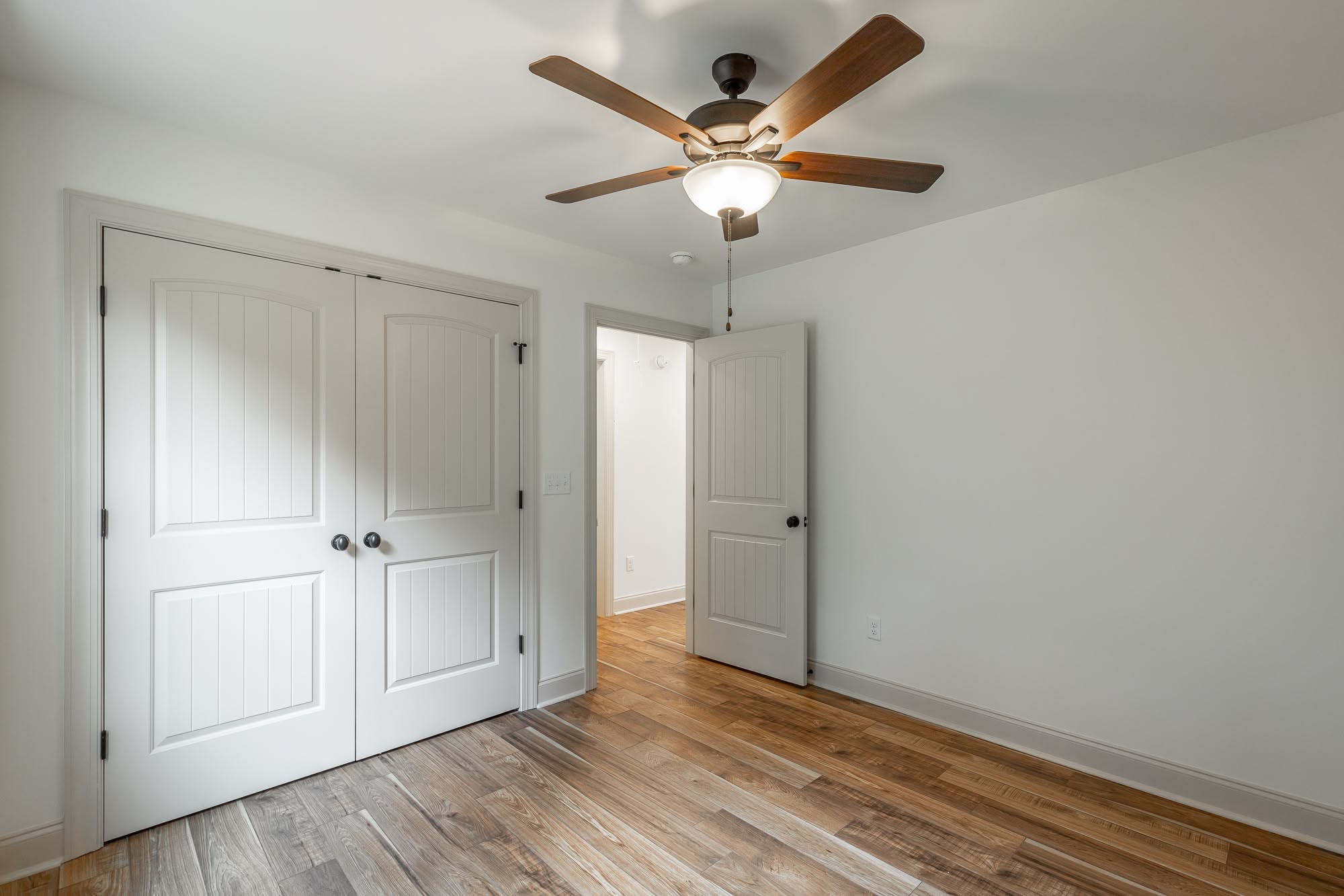 Open concept kitchen and living room with vaulted ceilings and hardwood floors