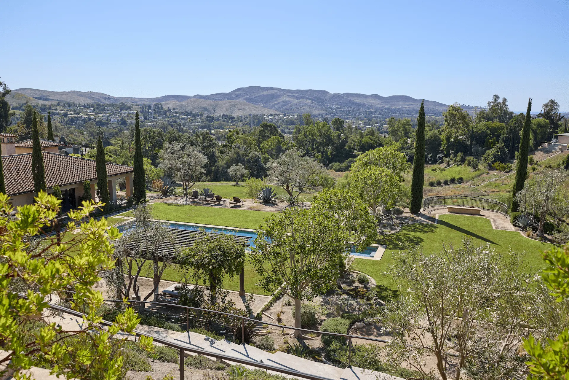 Beautiful view of the landscaped rear yard of the property from a house balcony. Photo by Todd Huge.