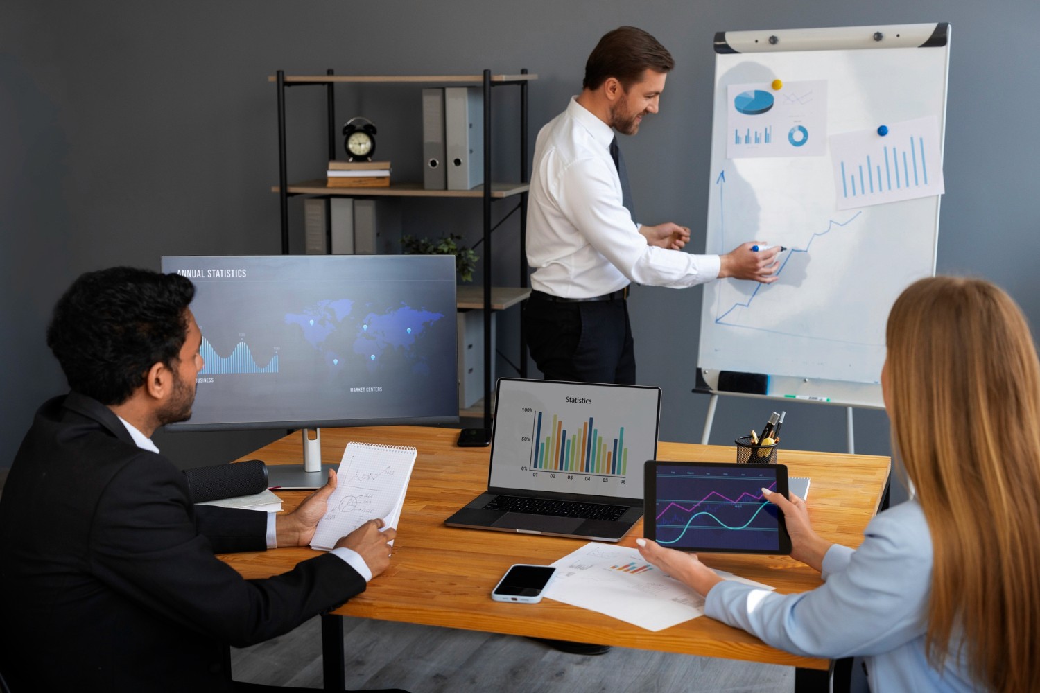 A group of business professionals collaborating in a modern office environment, focused on their tasks and discussions.