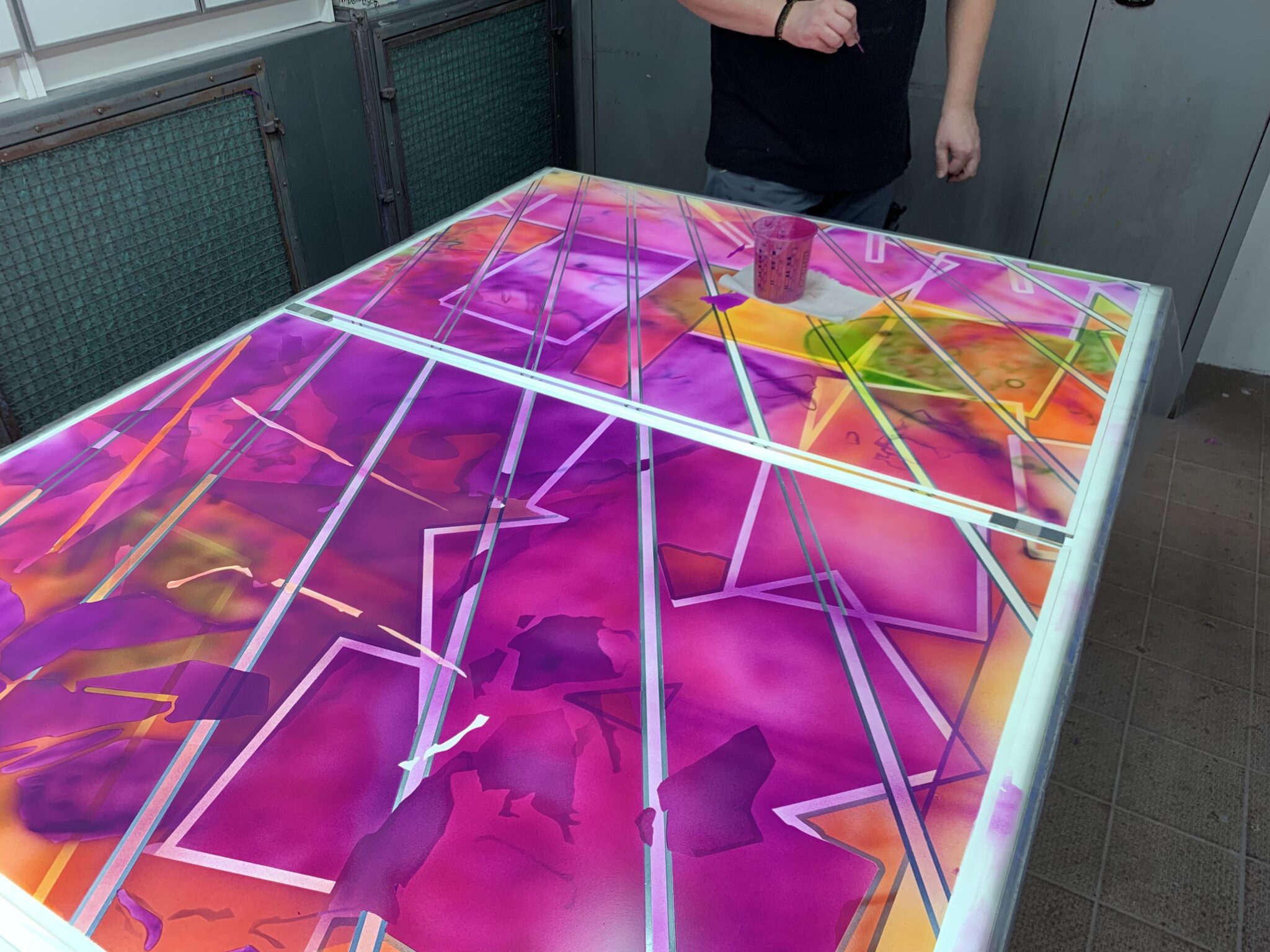 Handpainting in the spray booth at Derix Glasstudios