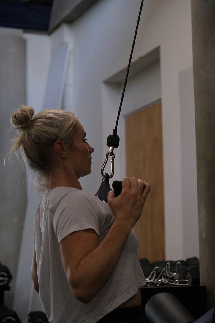 Personal trainer helping client with fitness
