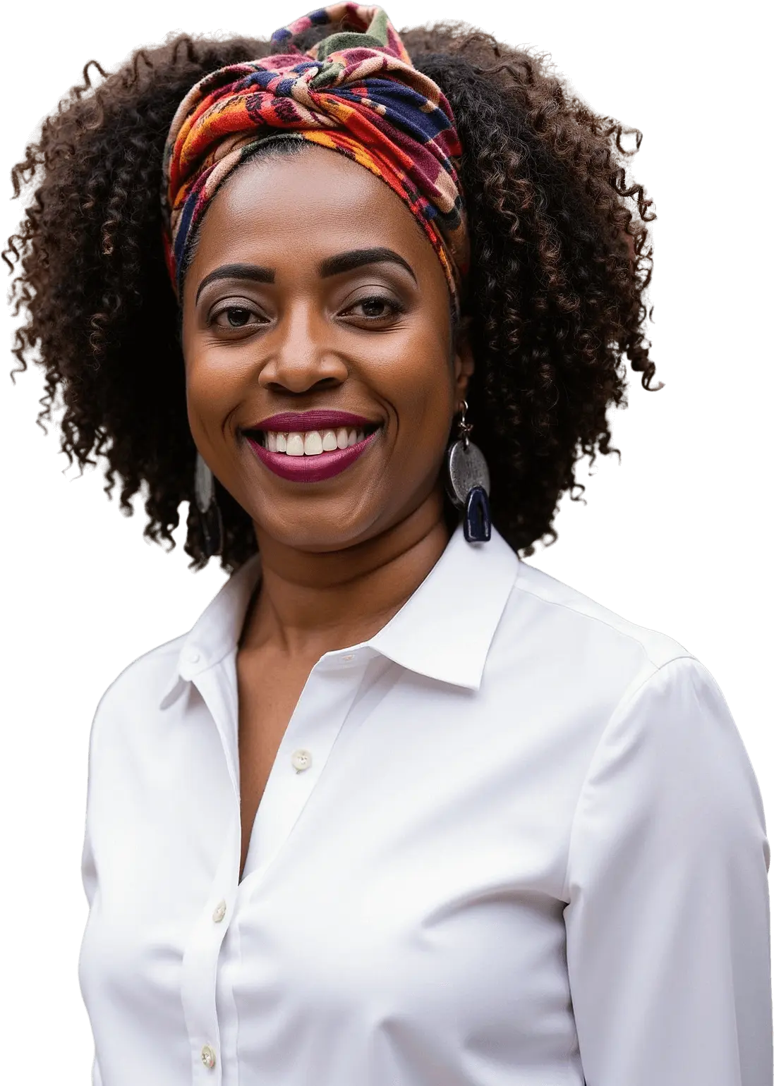 Smiling woman with curly hair and colorful headscarf in white shirt.