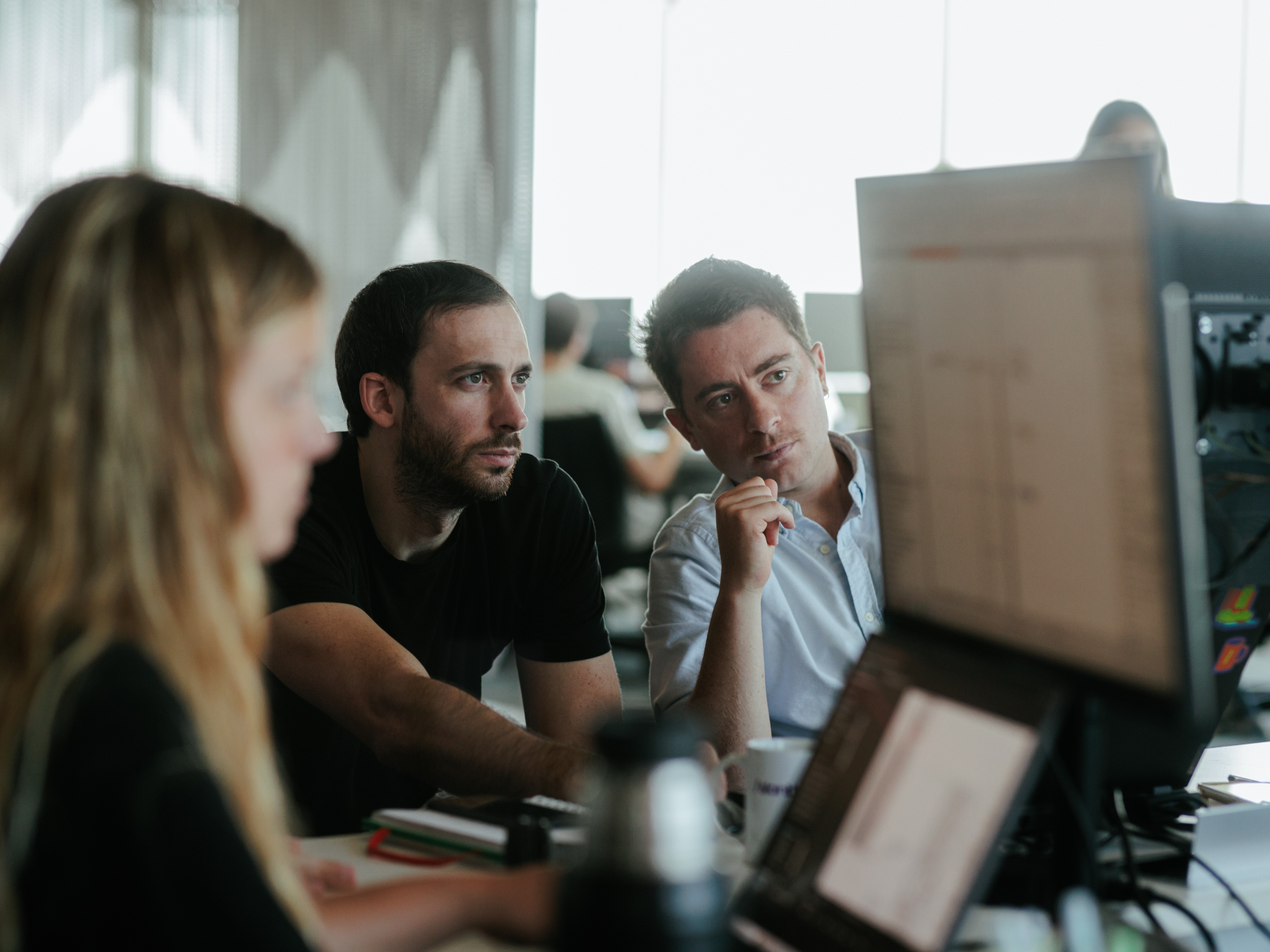 Three slanters working together at a desk