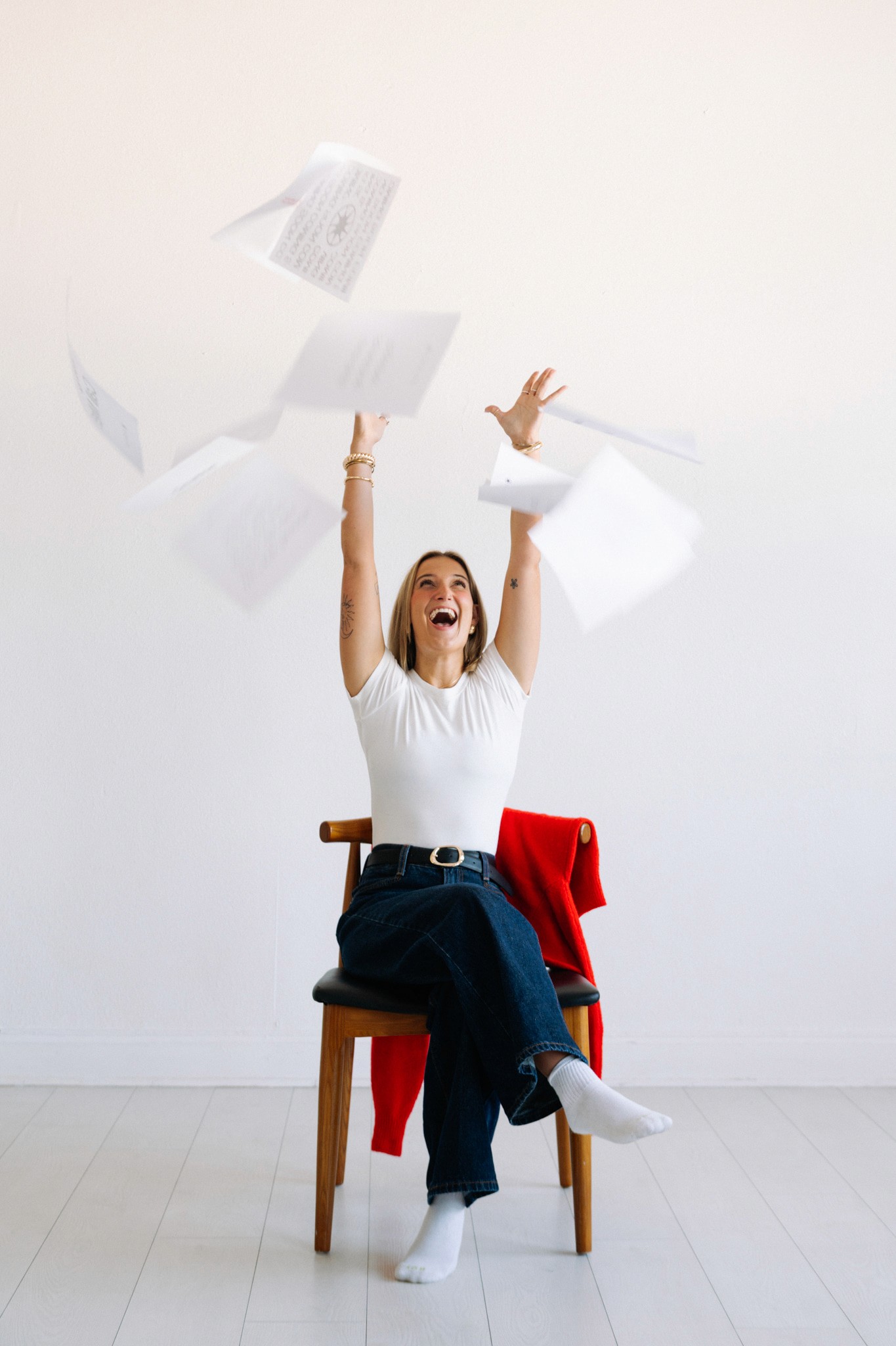 A close-up of a pink cocktail in a martini glass, set against a nighttime background with soft, blurred colors.