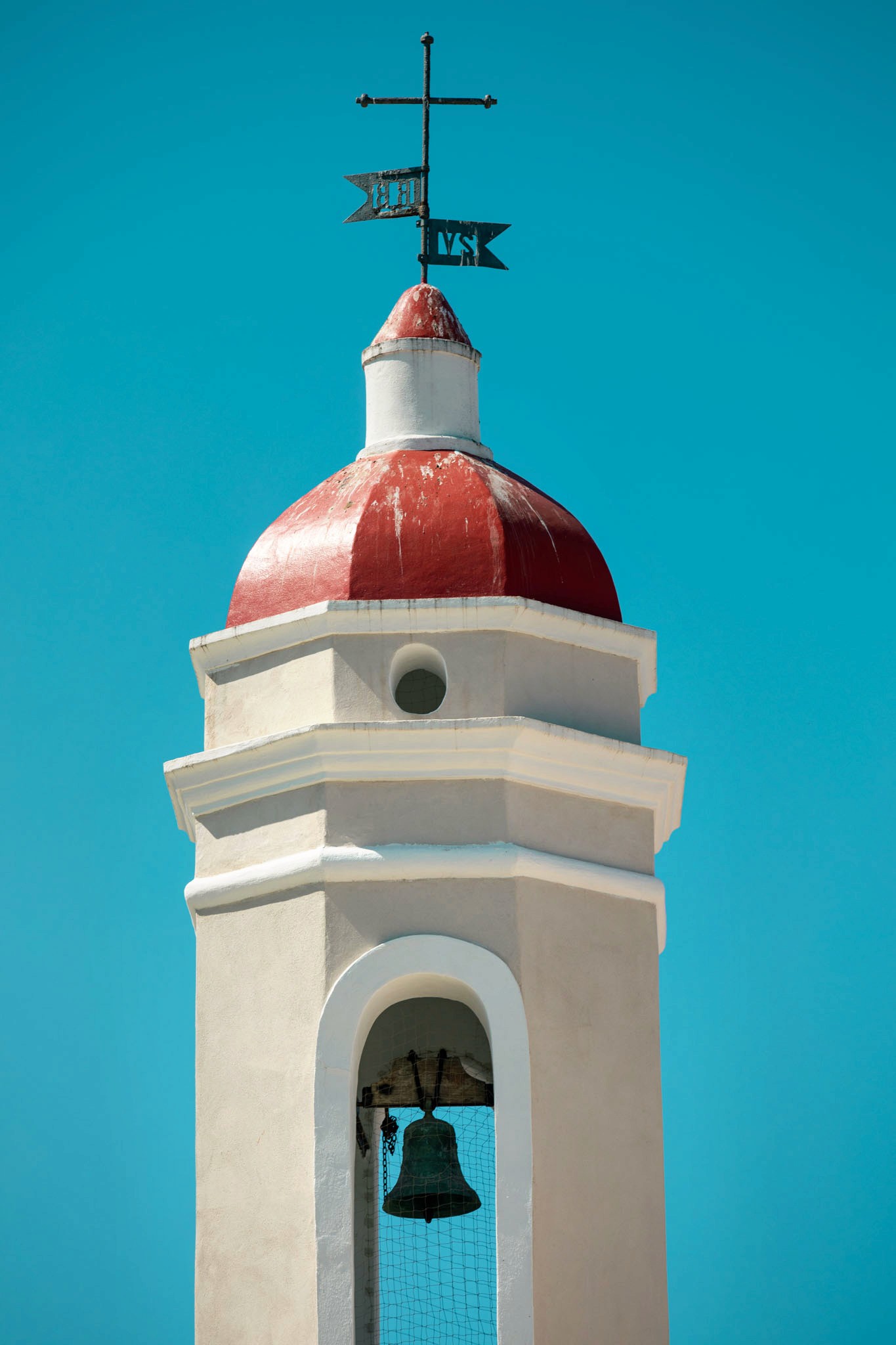 A couple stands outdoors at sunset.