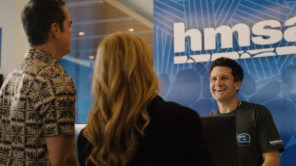 HMSA staff speaking with members inside office