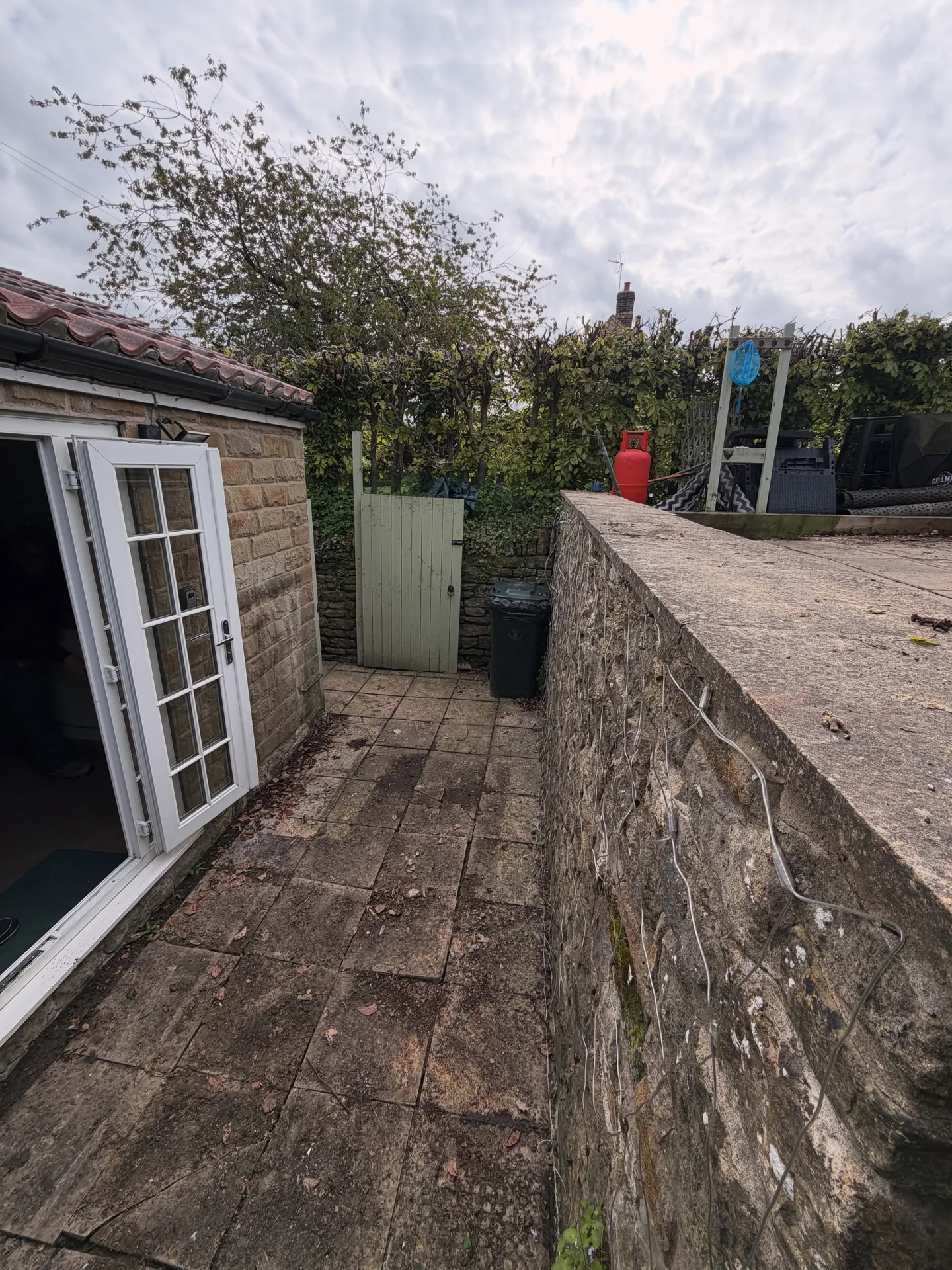 Old paved pathway beside the property before renovation