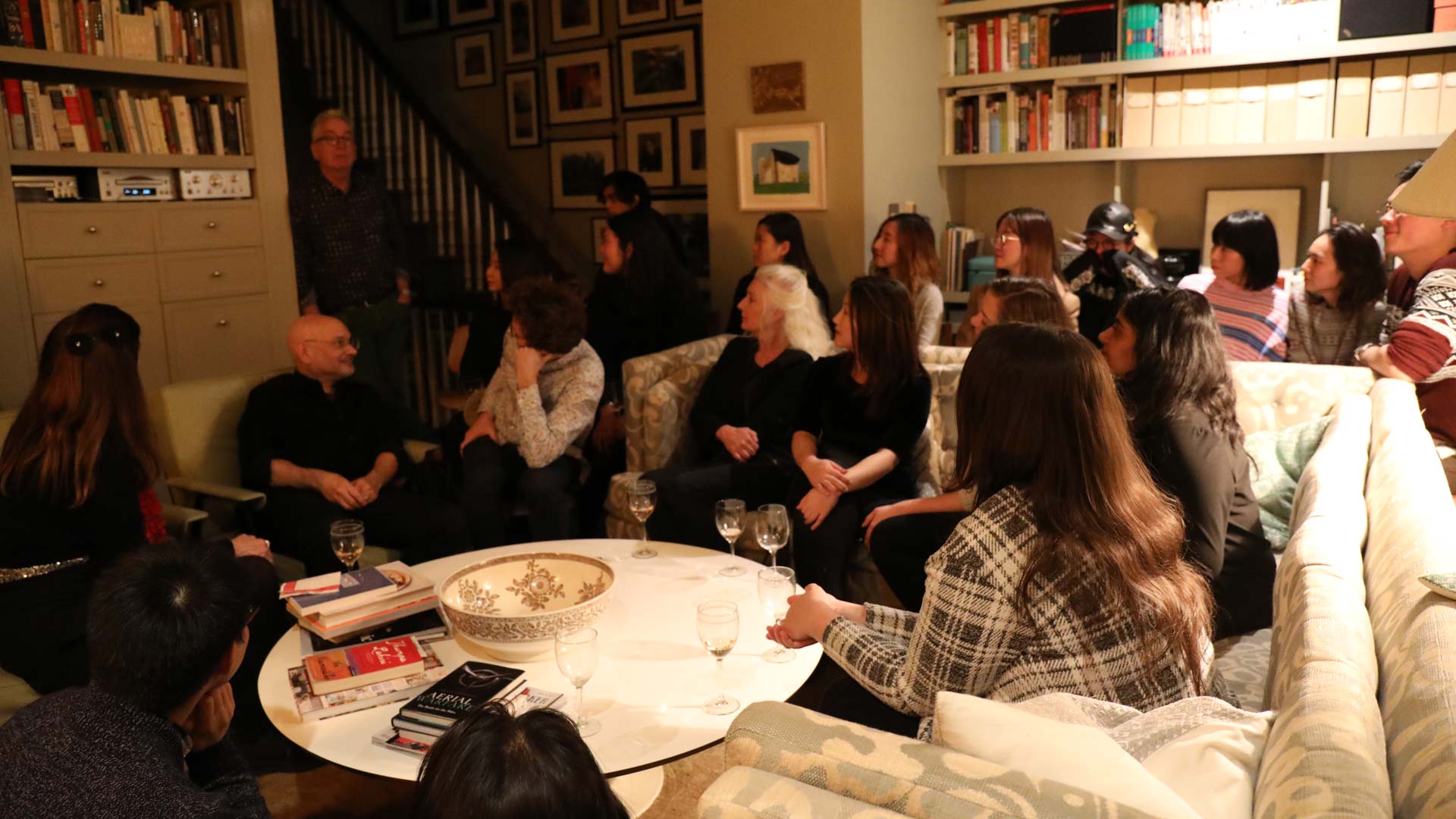 students and teachers in living room discussing semester