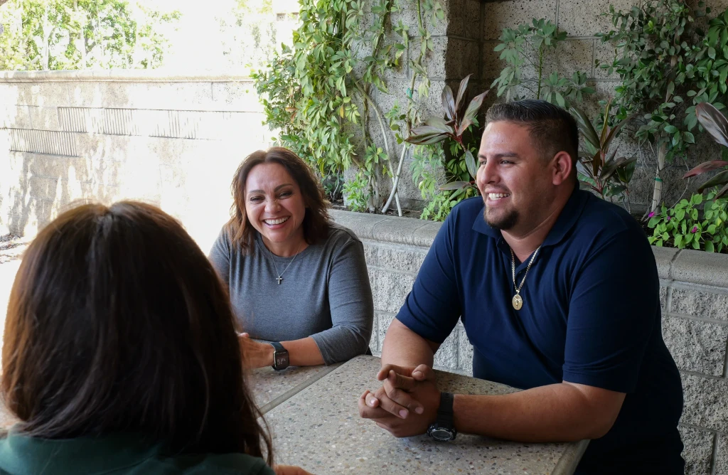 Employees talking happily at outdoor table