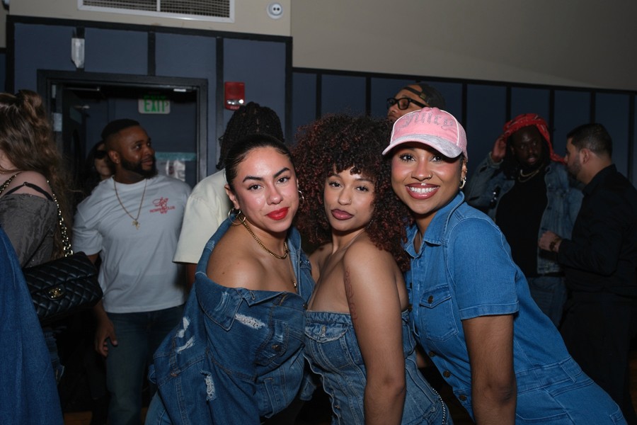 Three guests smiling at a nightlife event