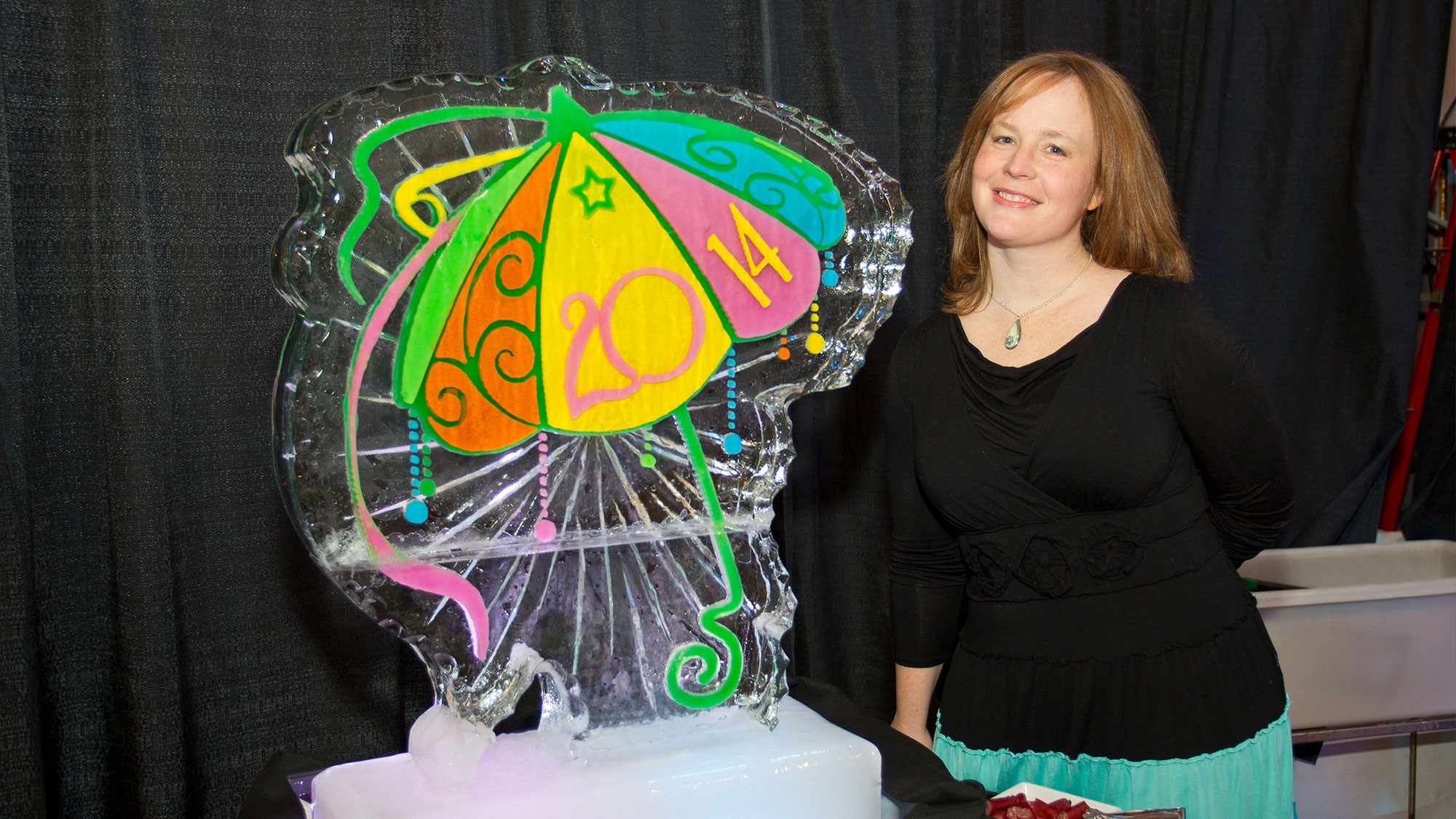 An Ice sculpture of a colorful umbrella with 2014 on it