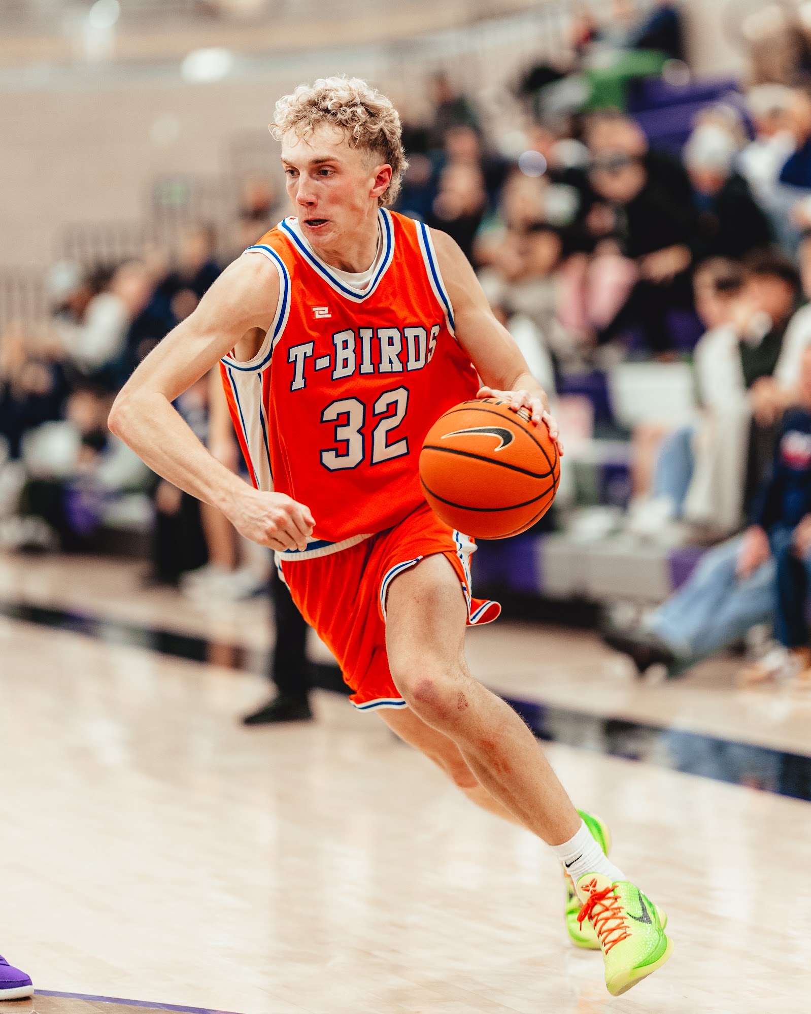 Three people sitting on a couch in a room looking at mobile devices