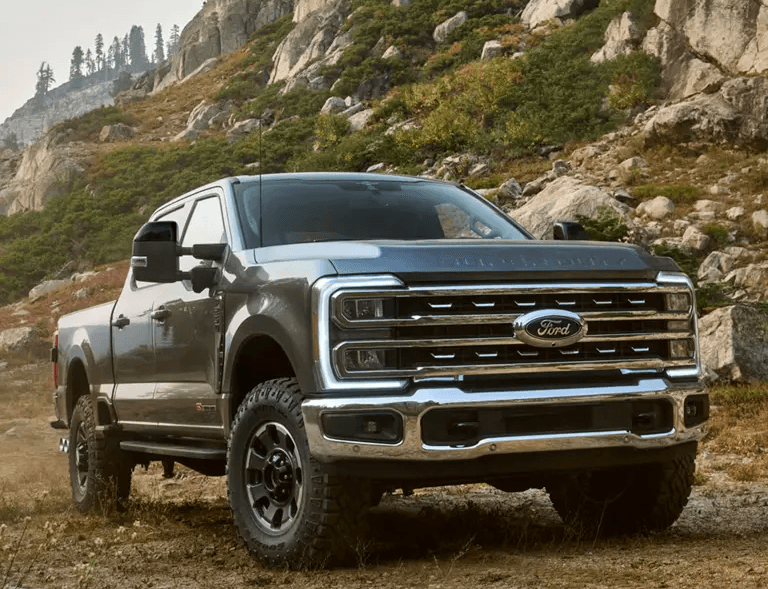 A person seated at SoFi Stadium holds a Bucked Up Energy White Gummy Deer can in one hand and a stadium-branded plastic cup in the other, wearing a bright blue “Bucked Up” t-shirt. The focus highlights the energy drink branding and casual game-day vibe.