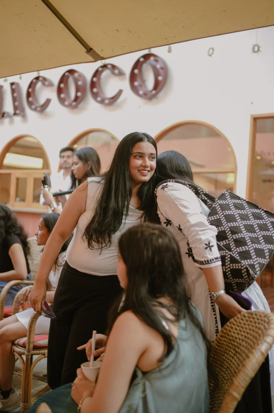 Sitara Foundation at a cafe with a "CHACOCO" sign.