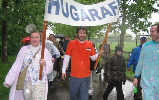 Scientist using a multi-channel pipette to transfer liquid samples in a lab, wearing gloves and surrounded by lab equipment.