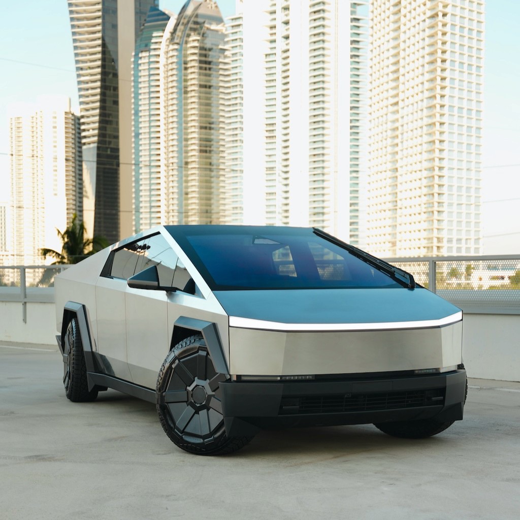 Front angle of a Tesla Cybertruck Cyberbeast parked in downtown Miami with skyline in the background.