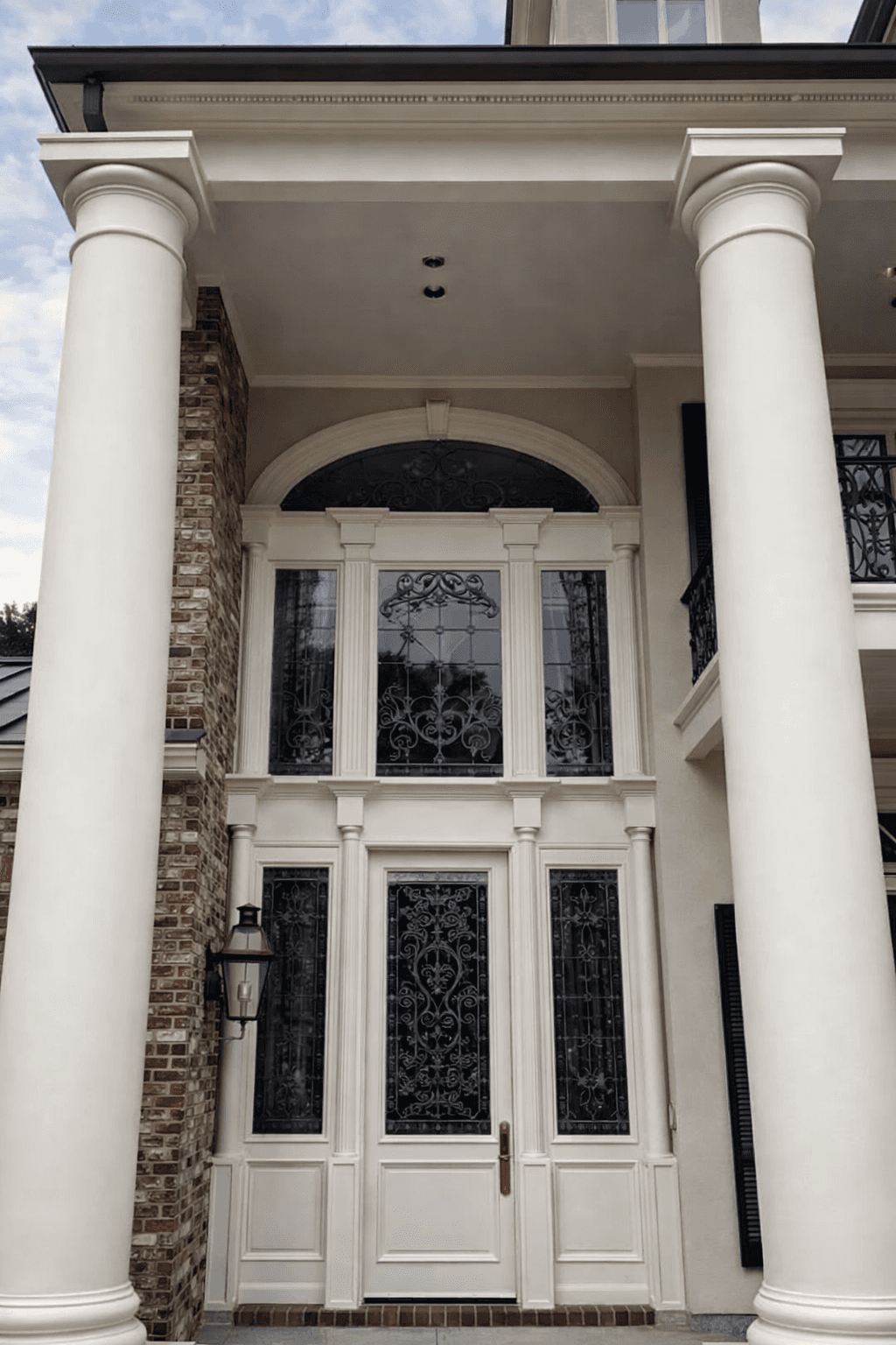 Modern living room with abstract art, beige sectional sofa, indoor plants, and large windows.