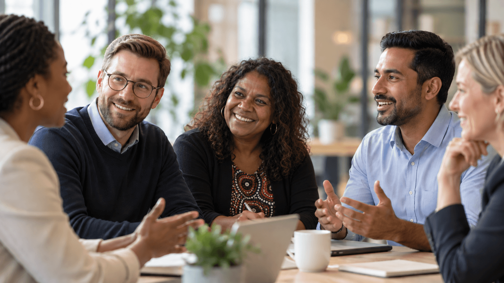 Diverse leaders in conversation during a collaborative workplace discussion