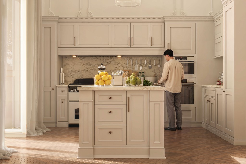 Luxury Parisian kitchen interior design with shaker-style cabinetry in warm greige, marble worktop kitchen island, marble slab backsplash, range cooker, herringbone parquet flooring, and double-height ornate plaster moulded walls