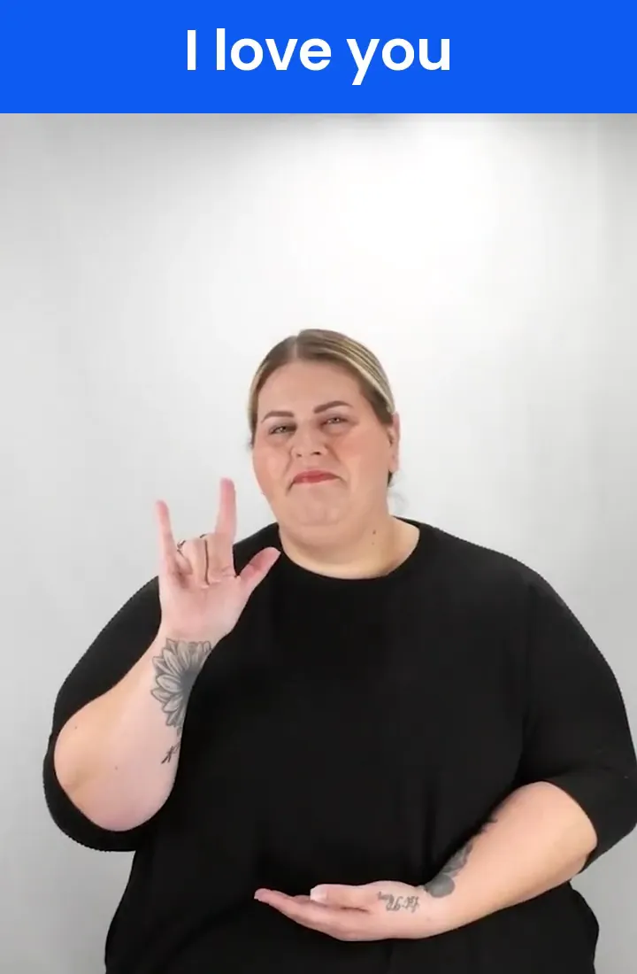 A Deaf signer signs I-LOVE-YOU in ASL
